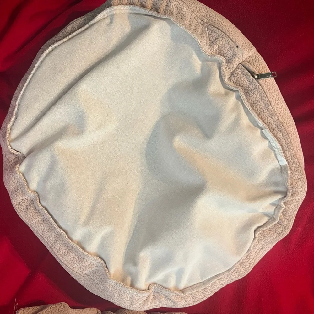 Gently used small dog or cat bed. Small round dog bed in a light color.
